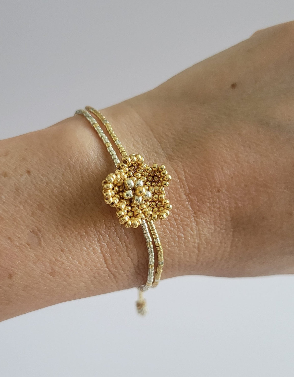 Little Bloom Bracelet in Golden Glow, worn on model – handwoven Miyuki jewelry by Franchesca Jewels
