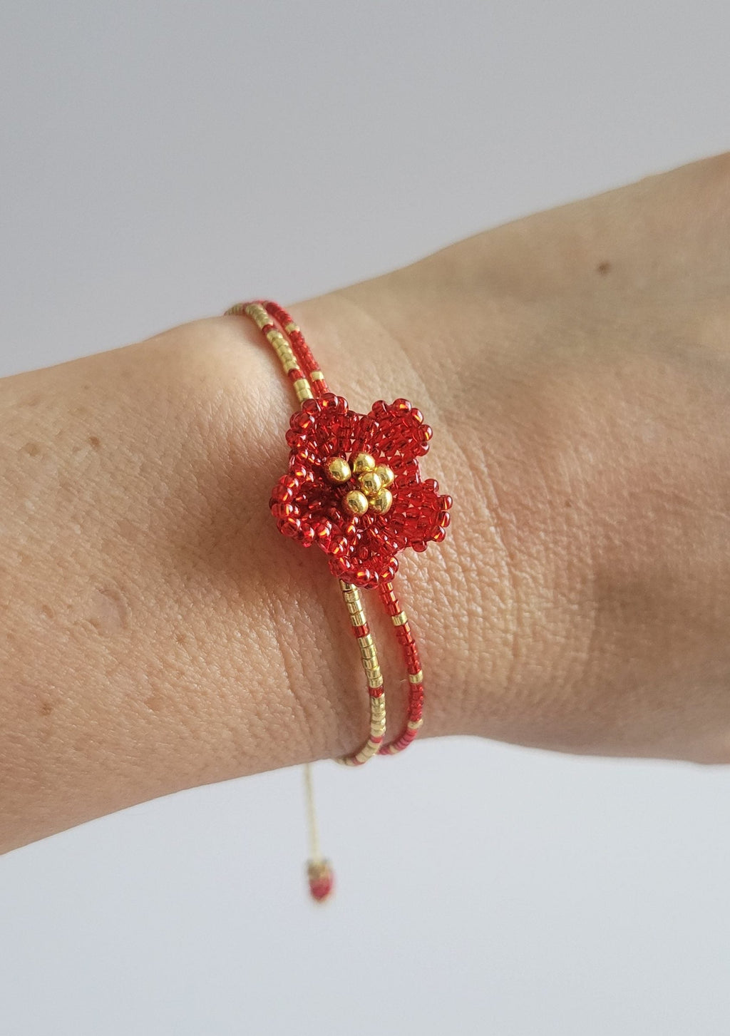Little Bloom Bracelet in Ruby Red, worn on model – handwoven Miyuki jewelry by Franchesca Jewels