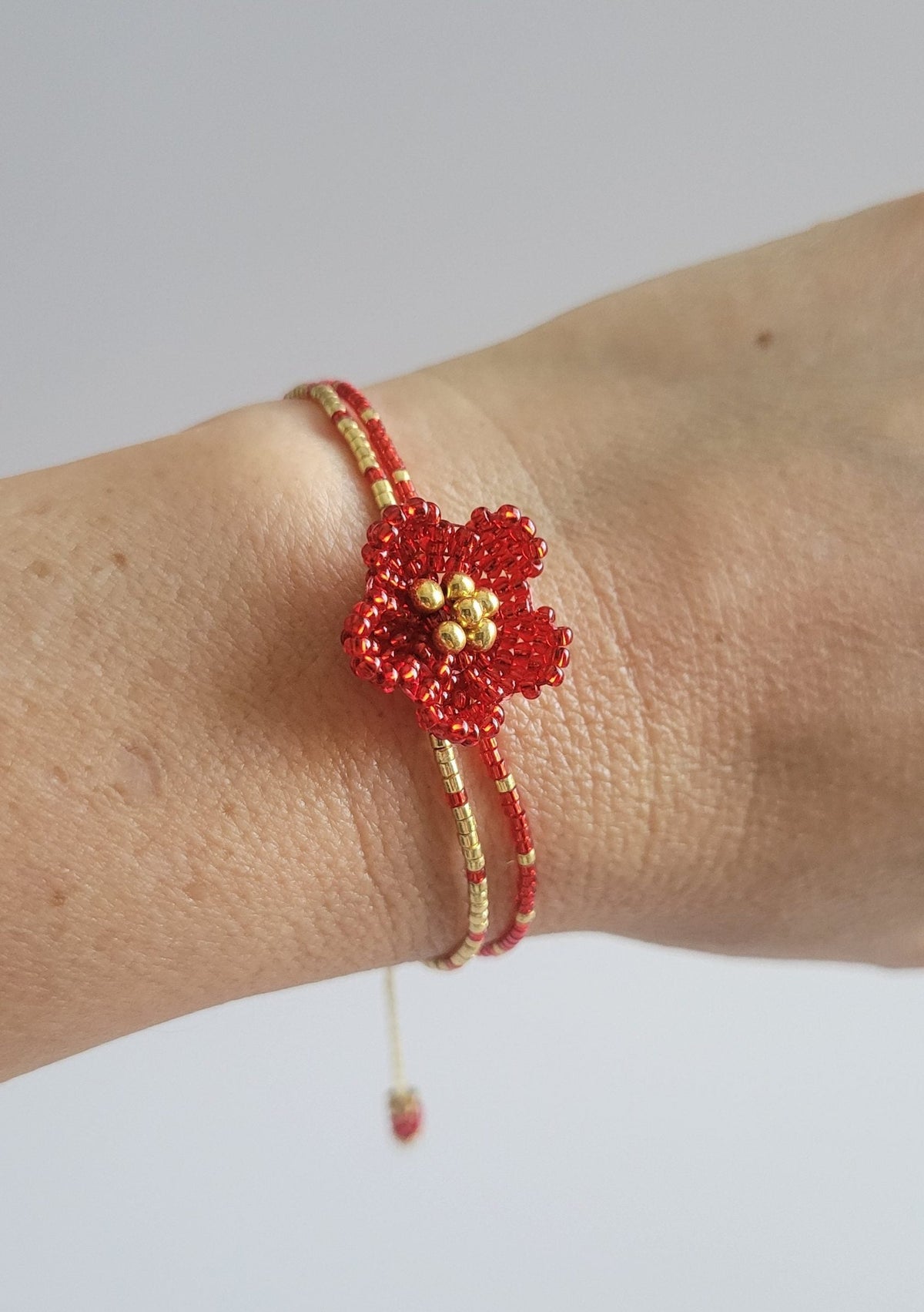 Little Bloom Bracelet in Ruby Red, worn on model – handwoven Miyuki jewelry by Franchesca Jewels