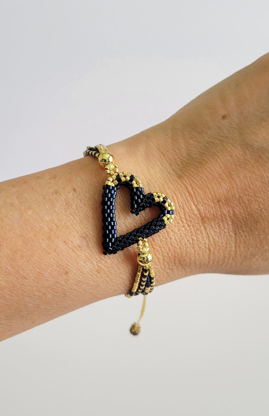 The Love Knot Bracelet in Blue Montana, worn on model – handwoven Miyuki jewelry by Franchesca Jewels
