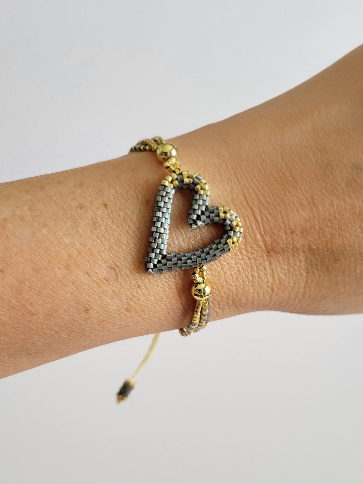 The Love Knot Bracelet in Graphite Luxe, worn on model – handwoven Miyuki jewelry by Franchesca Jewels