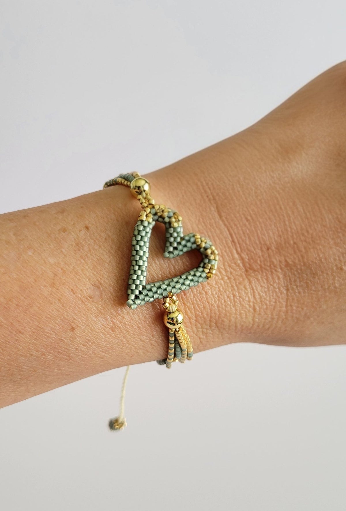 The Love Knot Bracelet in Sage Mist, worn on model – handwoven Miyuki jewelry by Franchesca Jewels